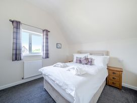 A bedroom with a bed and nightstand at Paddington Lodge Near Brigg