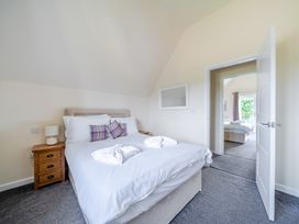 A bedroom with a bed and bedside table at Paddington Lodge near Brigg