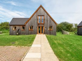 A house with wooden exterior and pathway at Charcoal Lodge in Brigg