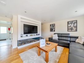 A living room with a television and sofa at Charcoal Lodge in Brigg