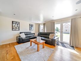 A living room with a sofa and coffee table at Charcoal Lodge in Brigg