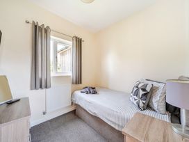 A bedroom with a bed and television at Charcoal Lodge in Brigg