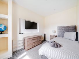 A bedroom with a bed and television at Charcoal Lodge in Brigg