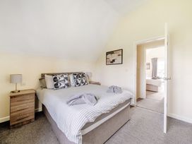 A bedroom with a bed and bedside table at Charcoal Lodge in Brigg
