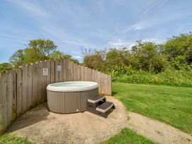 An outdoor area with a hot tub and steps at Charcoal Lodge in Brigg