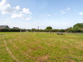 An outdoor area with soccer goal and swing set at Charcoal Lodge in Brigg
