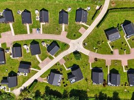 An aerial view of a residential area with houses and pathways at Charcoal Lodge in Brigg