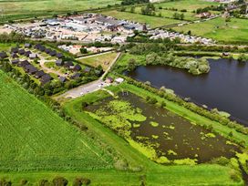 An aerial view of houses and a pond at Charcoal Lodge in Brigg