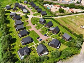 An aerial view of multiple houses and a pathway at Charcoal Lodge in Brigg