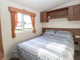A bedroom with a bed and window at 46 Foxburrow Hang in Great Yarmouth