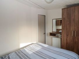 A bedroom with a bed and wardrobe at 46 Foxburrow Hang in Great Yarmouth