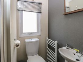 A bathroom with a toilet and sink at 46 Foxburrow Hang in Great Yarmouth