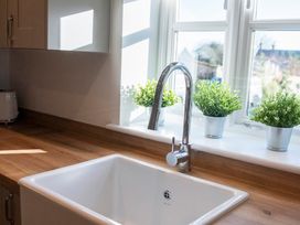A kitchen with a sink and faucet at The Old Boat House Lyme Regis