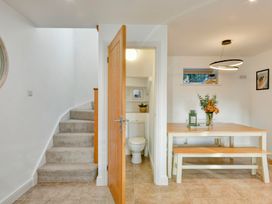 A dining room with a table and toilet visible at The Old Boat House in Lyme Regis
