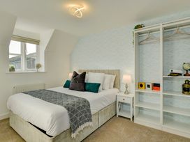 A bedroom with a bed and bookshelf at The Old Boat House in Lyme Regis
