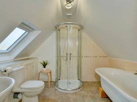 A bathroom with a shower, bathtub, and toilet at The Old Boat House in Lyme Regis