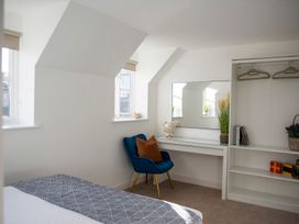 A bedroom with a desk and a chair at The Old Boat House in Lyme Regis