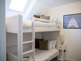 A bunk bed with pillows and a lamp in a bedroom at The Old Boat House in Lyme Regis