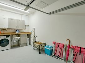 A laundry room with a washing machine and storage cabinets at The Old Boat House in Lyme Regis