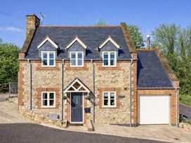 A house with a stone exterior and garage at The Old Boat House in Lyme Regis