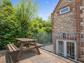 A patio with a table and bench at The Old Boat House in Lyme Regis