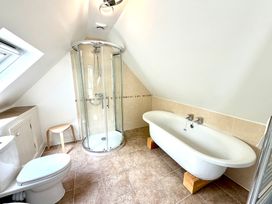 A bathroom with a shower and bathtub at The Old Boat House in Lyme Regis