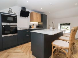 A kitchen with a modern design including a kitchen island and appliances at The Old Bakehouse