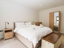 A bedroom with a bed and bedside table at The Old Bakehouse in 