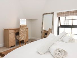 A bedroom with towels on the bed at The Old Bakehouse 