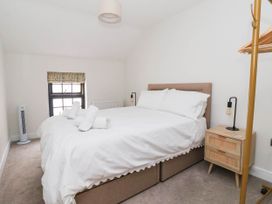 A bedroom with a bed and bedside table at The Old Bakehouse 
