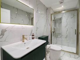 A bathroom with a shower and sink at The Old Bakehouse