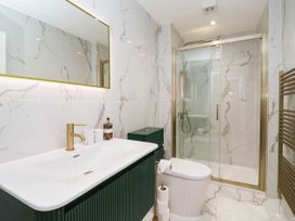A bathroom with a sink, toilet and shower at The Old Bakehouse in 