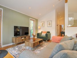 A living room with a television, coffee table, and sofa at 6 Stonerush Valley, Looe