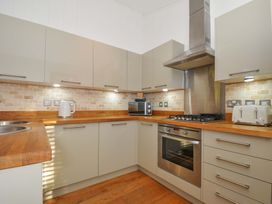 A kitchen with modern appliances and wooden countertop at 6 Stonerush Valley in Looe