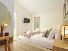 A bedroom with a bed and television at 6 Stonerush Valley Looe