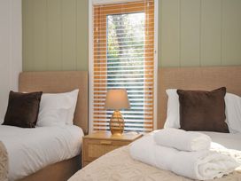 A bedroom with two beds and a window at 6 Stonerush Valley Looe