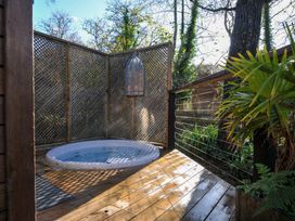 An outdoor area with a hot tub and wooden deck at 6 Stonerush Valley Looe