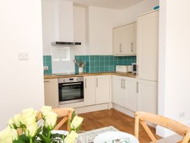 A kitchen with cabinets and appliances at The Old Bank Flat North Tawton