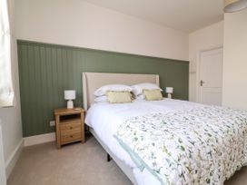 A bedroom with a bed and bedside table at The Old Bank Flat in North Tawton
