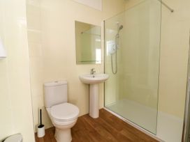 A bathroom with a sink and shower at The Old Bank Flat in North Tawton