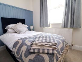 A bedroom with a bed and a radiator at The Old Bank Flat in North Tawton