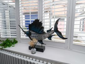A decorative fish sculpture on a windowsill at OG's House in Whitby