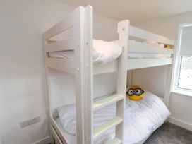 A bedroom with a bunk bed and a stuffed toy at OG's House in Whitby