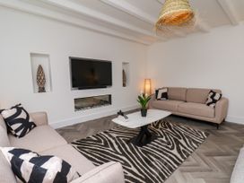 A living room with a television, sofa, and coffee table at Og's House in Whitby