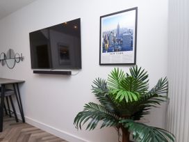 A living room with a television and wall art at Og's House in Whitby