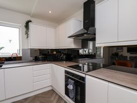 A kitchen with modern appliances and cabinetry at Og's House in Whitby