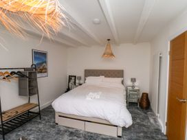 A bedroom with a bed and a clothes rack at Og's House in Whitby