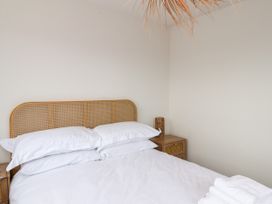 A bedroom with a bed and bedside table at Og's House in Whitby