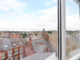 A view of rooftops and buildings from a window at Og's House in Whitby