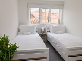 A bedroom with two single beds at Og's House in Whitby